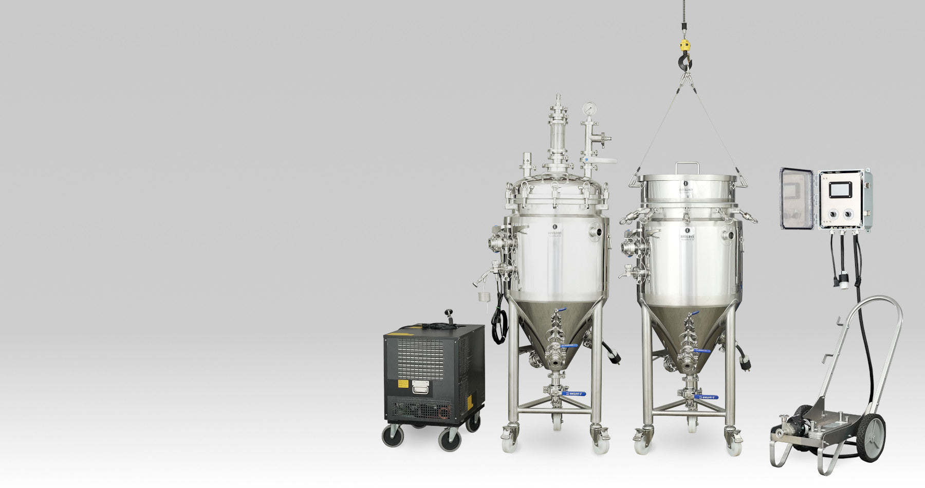 Set of brewing equipment including tanks and a control panel on a gray background