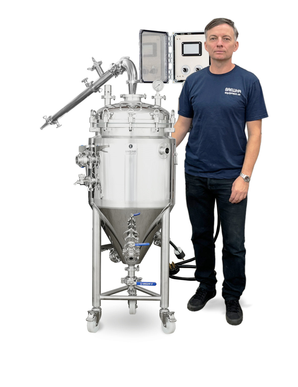 Person standing next to a large stainless distilling vessel on a white background